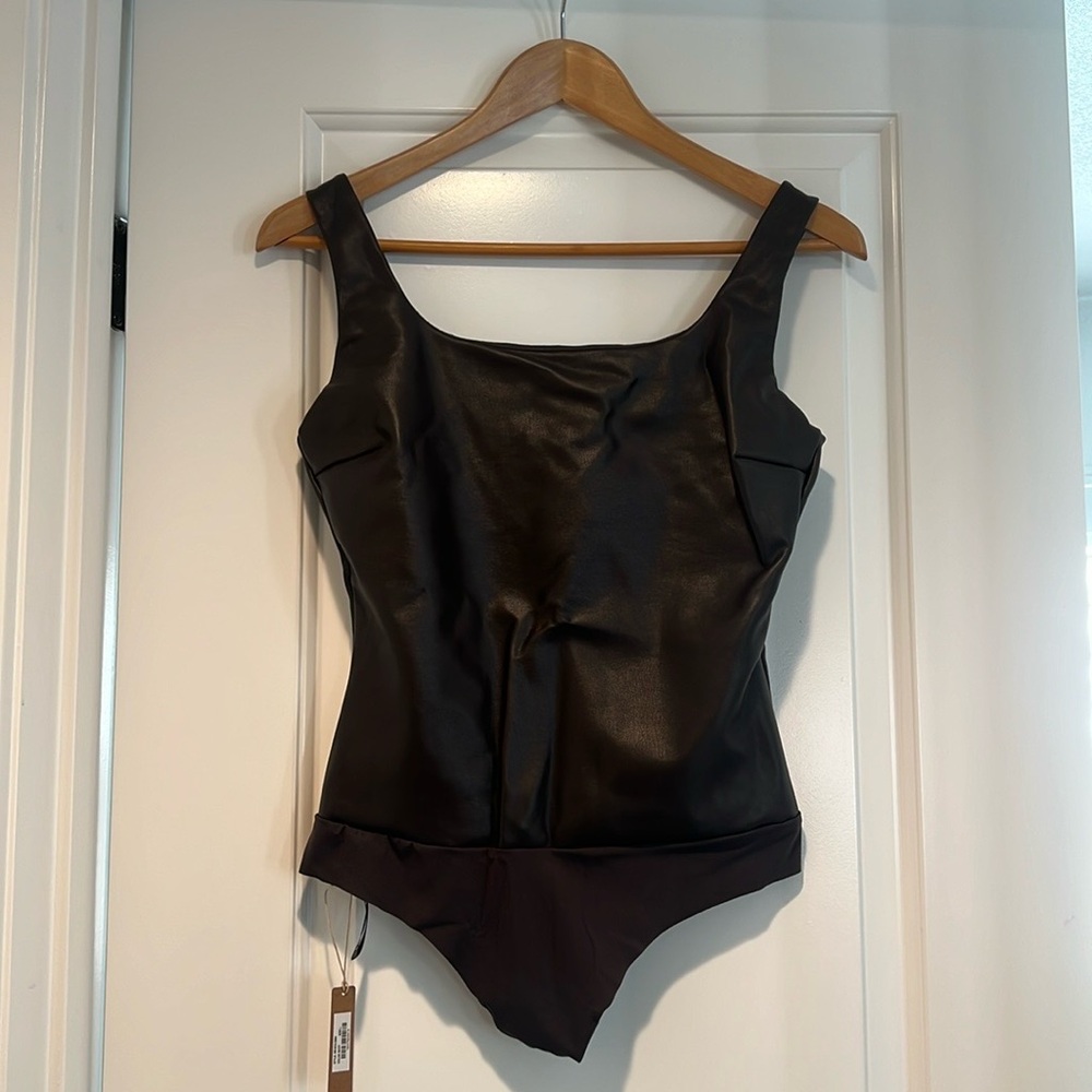 Brand new Skims faux leather body suit in the color Soot in a size large.